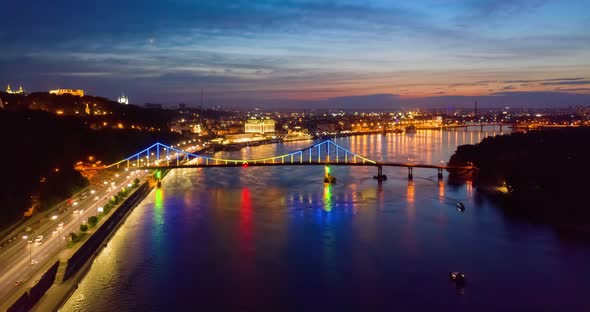 Night Cityscape. Colorful Glowing Led Bridge Across River and Quay Road in Kyiv