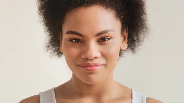 Portrait of happy smiling african american woman looking at camera. Real people human face alt