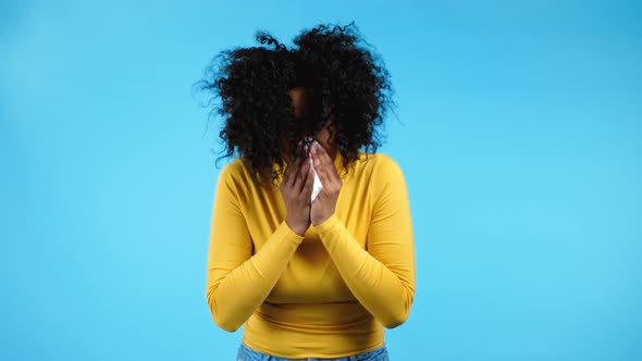 African Woman Sneezes Into Tissue alt