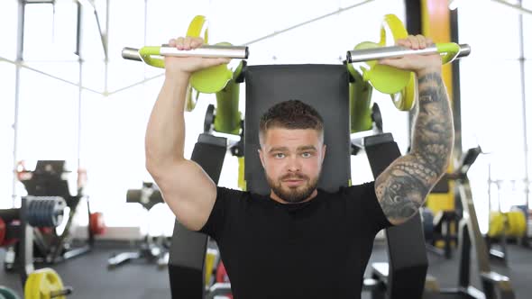 Adult Male Athlete Doing Torso Strength Exercises in the Gym Using Sports Equipment