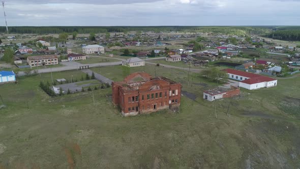 Aerial view of merchant abandoned ruined old red brick house in village 02 alt