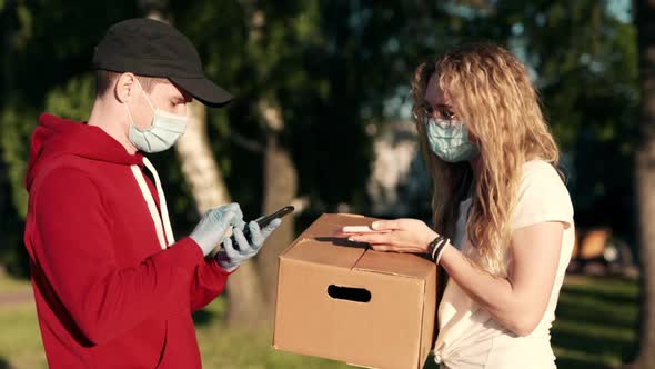 Customer Pretty Woman Paying for Lunch Box Using NFC Technology with Phone and Credit Card alt