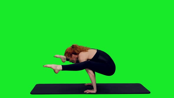 Sporty Woman Standing on Hands in Pose During Yoga Exercise on Green Screen