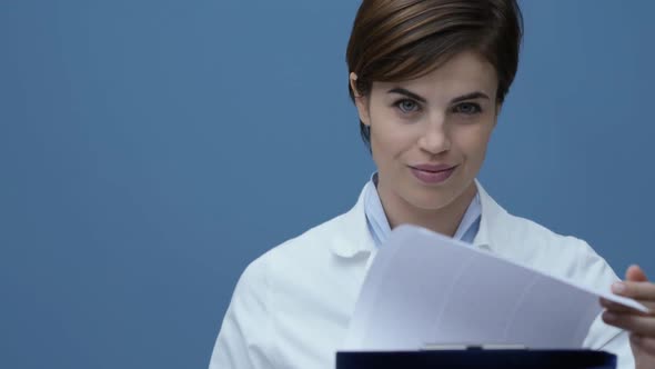 Female doctor checking medical records