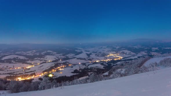Time Lapse Video with Blue Sky Fog and Snow of a Starry Sky Over Snowy Ski Resort in the Mountains