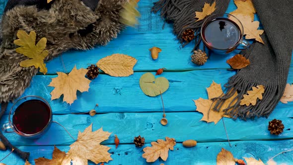 Yellow Foliage Falls On A Tea Table, Autumn Background With Tea And Leaves Fall