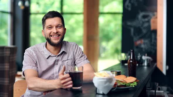 Portrait Adorable Smiling Bearded Man Posing in Sport Pub Looking at Camera Feeling Positive Emotion alt