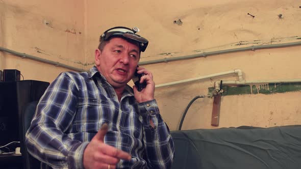 Closeup of the Master Speaks on the Phone with a Smile Accepts the Order alt