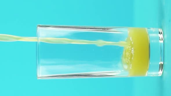 Vertical Video Slow Motion Closeup Shot of Fruit Orange Multifruit Juice Cold Beverage Drink Pooring