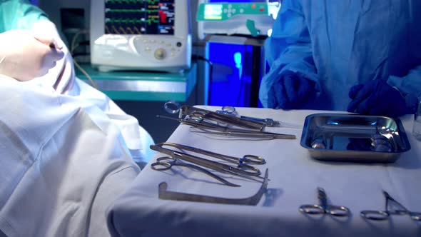 Nurse Providing Surgeon with Tools During Surgery