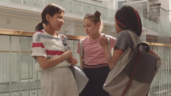 Multiethnic School Girls Chatting between Classes alt