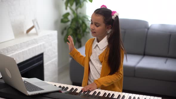 Little Girl Watching Online Lesson Tutorial How to Learn a Synthesizer alt