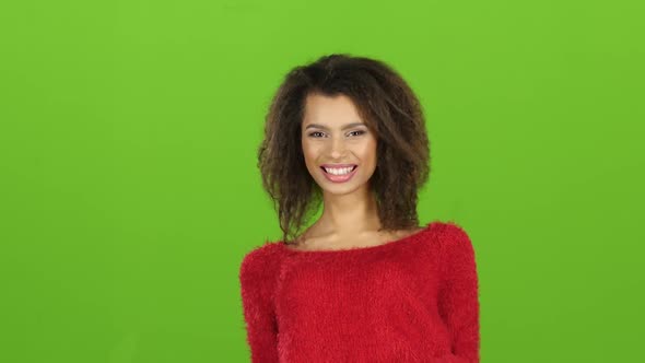 Afro American Woman in Red Sweater Contagiously Laughs, Green Screen alt