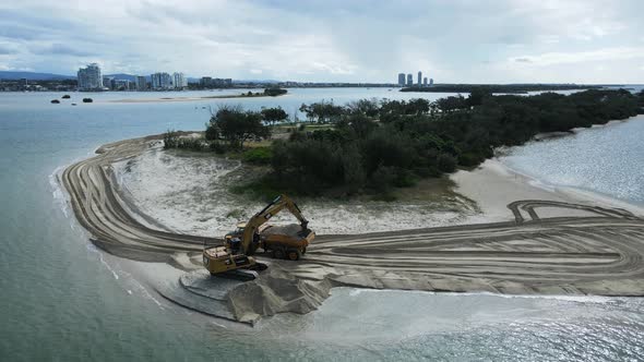 Large machinerying sand on a coastal rejuvenation project close to a urban city skyline. Panoramic d alt