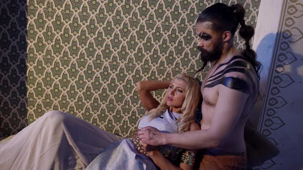 Caress of Earth Woman and Demon Man Lovers are Embracing in Bedroom at Night alt