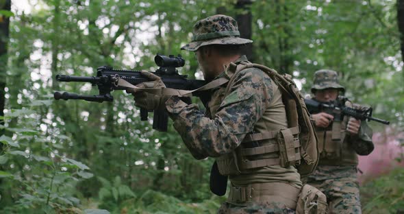 Soldiers Taking Aim From Rifle in Forest Smoke in Background Military and Army Concept alt
