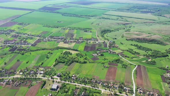 A bird's eye view of the village and spring fields.