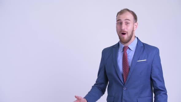 Happy Bearded Businessman Touching Something and Looking Surprised