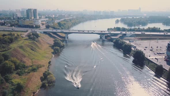 Aerial View of the Extreme Summer Time on the River. Man Water Skiing. Man Riding a Wakeboard on