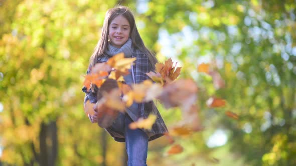 Cute Girl Plays in A Beautiful Autumn Park