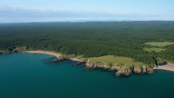 Drone flight above a picturesque rocky coastline alt