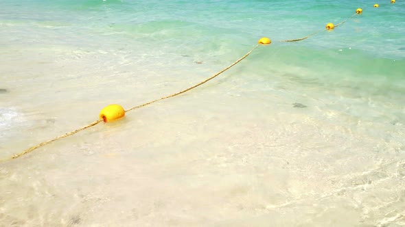 Yellow Buoy with Wave on the Beach  alt