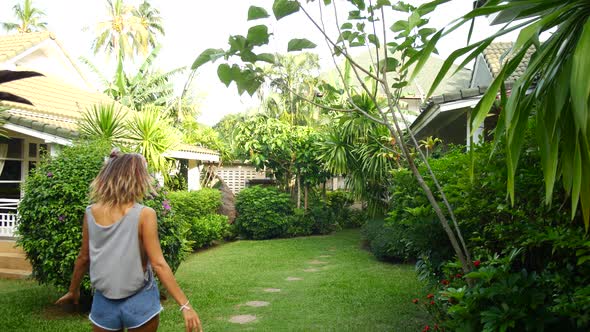Young Woman Walking to Her Summer House Tropical Resort