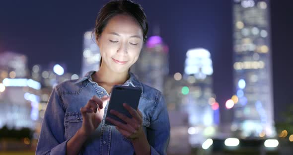 Woman use of smart phone at night  alt