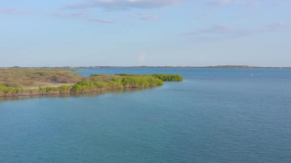 Aerial forward over waters of Sabana Buey in Dominican Republic. alt