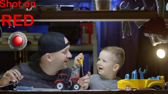 Dad Shows His Little Boy How To Work With Building Tools Fixing Toy Tractor Together In Workshop alt