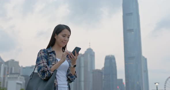 Woman Use of Mobile Phone for Text Message in City alt
