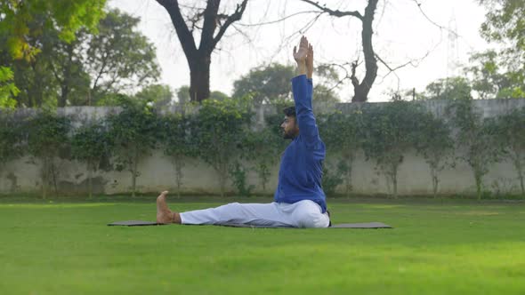Folded Leg Forward Bend Yoga Pose or Triang Mukha Eka Pada Paschimottanasana is being done by Indian alt