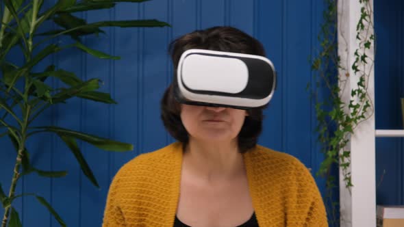 Middle Aged Woman Using Innovative Technology Vr Glasses for Play Games and Relax Herself After Hard