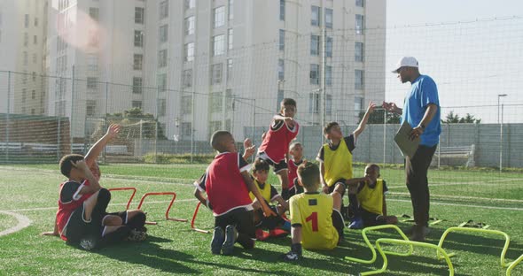 Soccer kids exercising in a sunny day alt