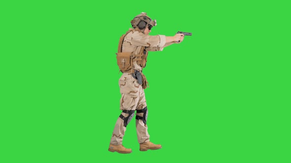 Marine Walking with Pistol and Shooting on a Green Screen, Chroma Key. alt