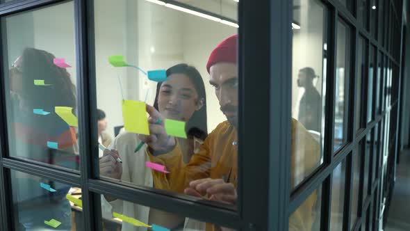Creative Design Team Shot Through Glass Partition alt