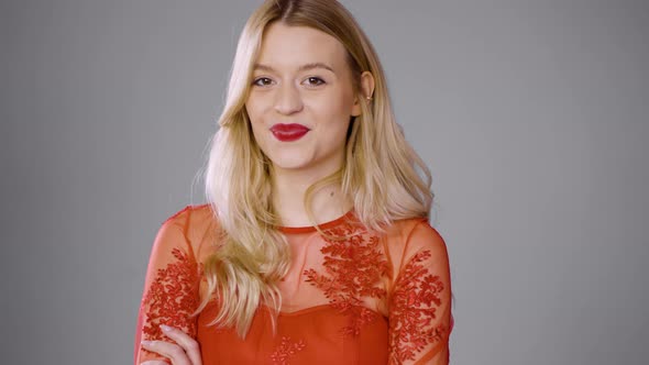 Lovely Woman with Red Lips Winking at Camera alt