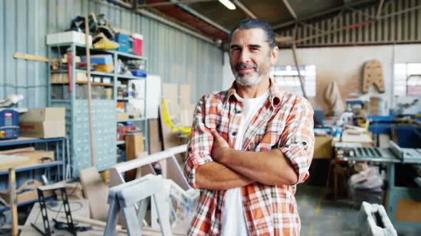 Smiling carpenter fixing the camera alt