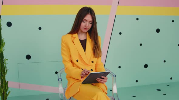 Woman In Yellow Suit Uses Gadget
