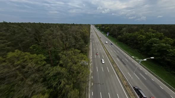 FPV Flight Along a Nearly Empty Highway Passing Through the Forest