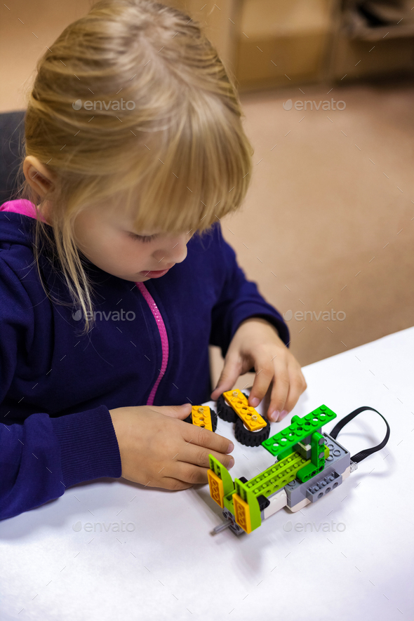 Learning robotics basics concept. Kid girl 5 year construct robotic ...