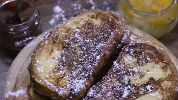 Pouring pieces of peach over rotating French toasts