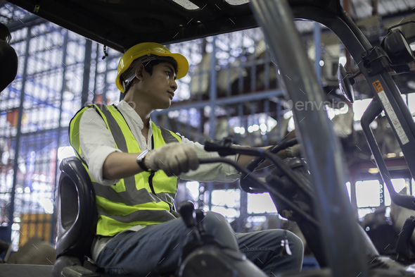Man wear safety helmet driver forklift warehouse in factory. Male ...