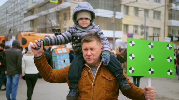 Dad and Kid at Demonstration to Stop Government Corruption Demand for Justice