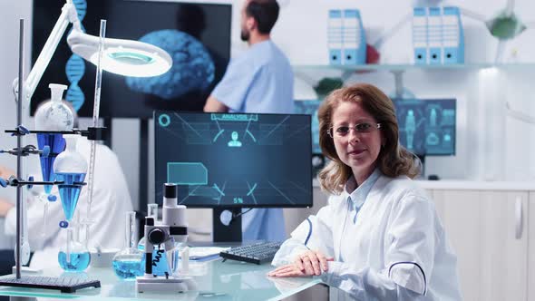 Portrait of Female Researcher at Her Desk alt
