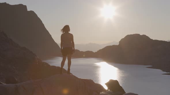 Adventurous Caucasian Adult Woman Hiking on Top of a Canadian Rocky Mountain alt
