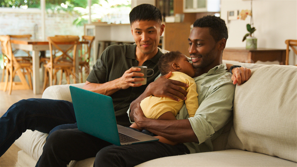 Same Sex Male Couple Family Bonding in Cozy Living Room With  