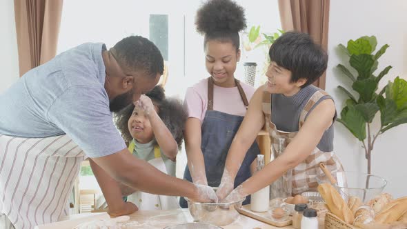 African America family wearing apron thresh flour for cooking bakery or bread together.