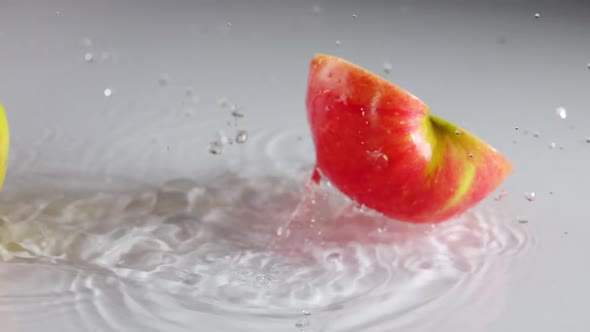 Apple Falls on the Table With a Thin Layer of Water