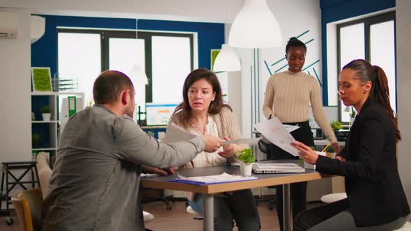 Diverse Businesspeople Brainstorming While Meeting Together at Company Office alt